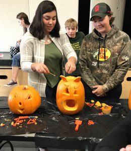Student and teacher with craved pumpkins