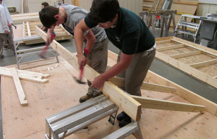 IMG_0013 A picture of students building the frame of a wall.