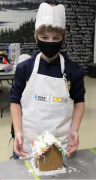 photo of student building gingerbread house