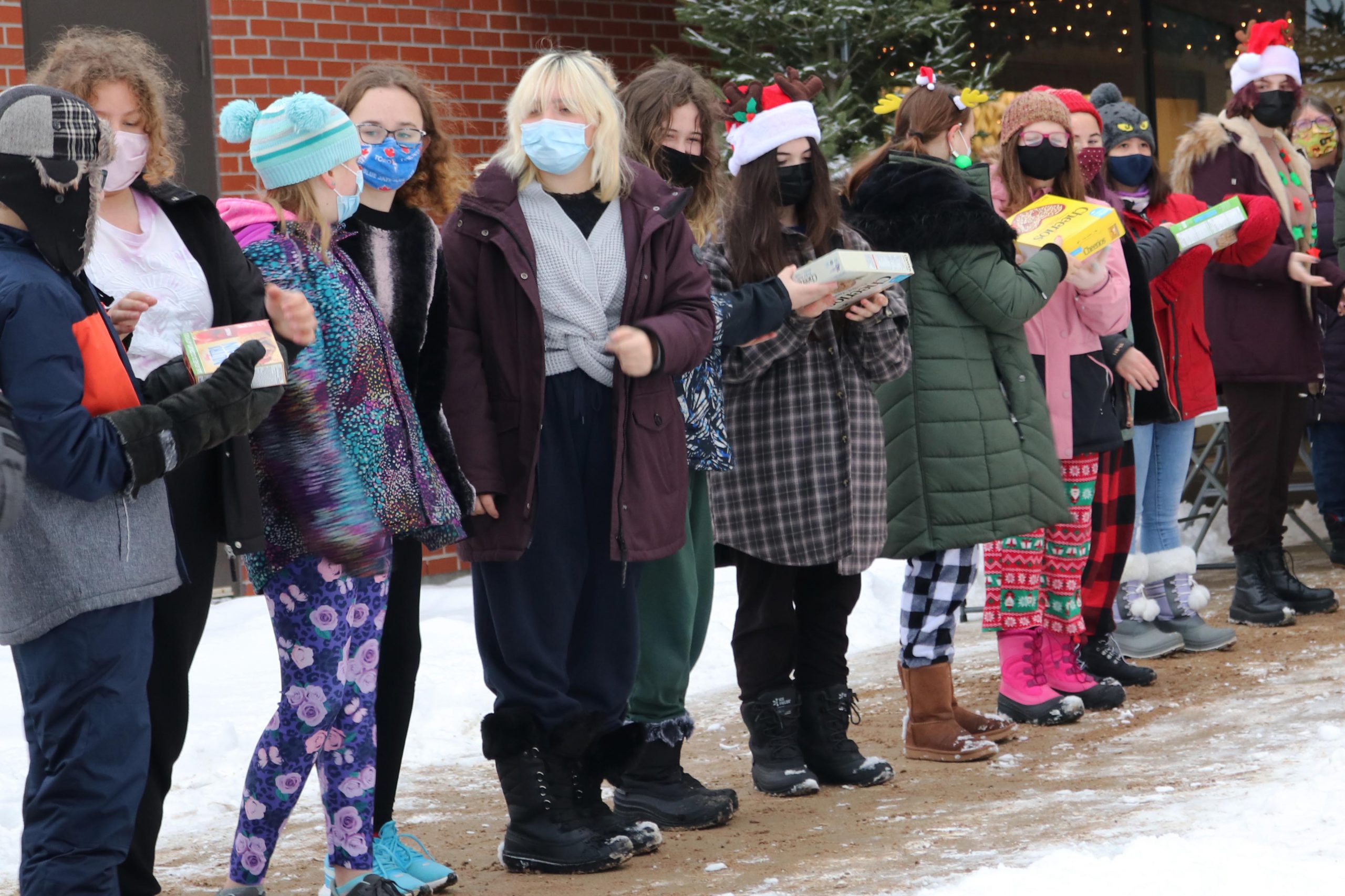 Students at Mapleridge Public School create human chain of donations to the local food bank.
