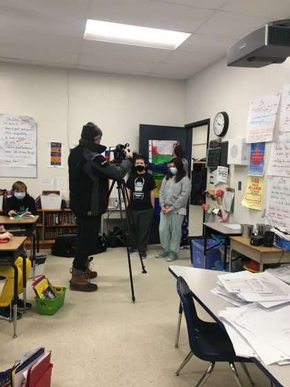 students being recorded by TV journalist