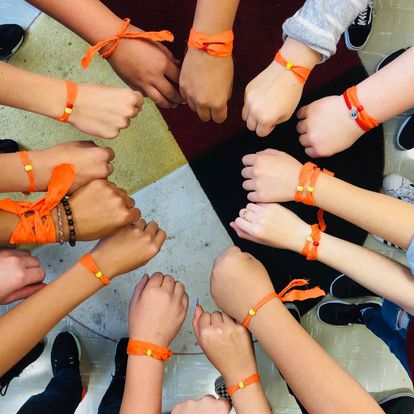 Arms with orange wrist bands