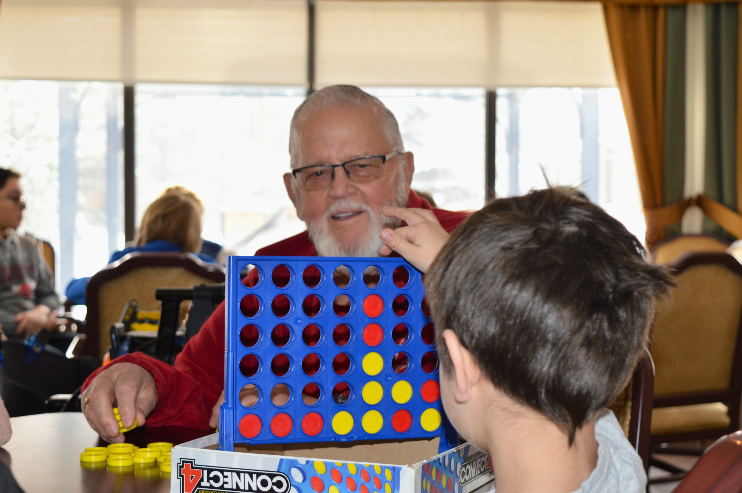 Older man playing game with student
